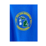 Old Coleman Parts royal blue t-shirt featuring a circular 2026 ICCC Convention logo with a lantern and Michigan map.
